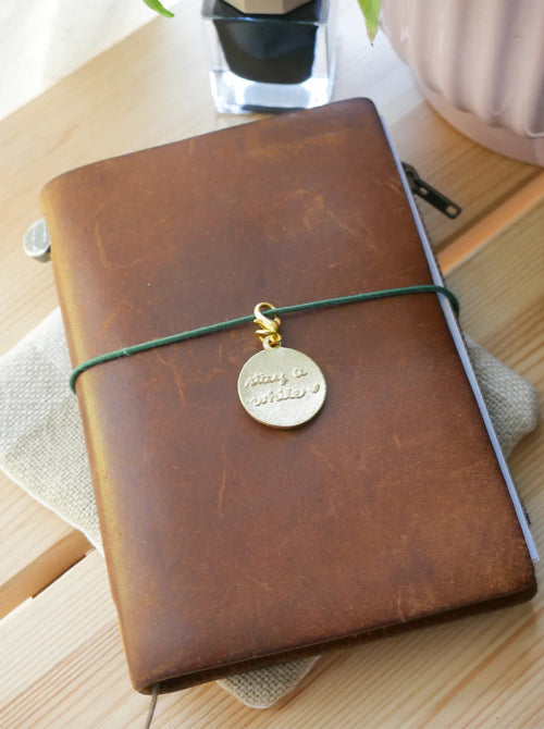 "Stay a While" Brass Charm